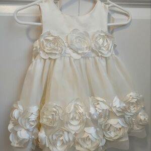 Like New 3/6 month white dress with satin flower detailing.